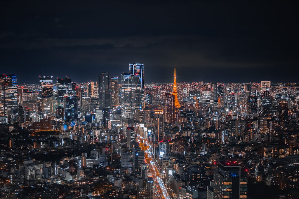 A breathtaking view of Tokyo's skyline at night featuring the illuminated Tokyo Tower.