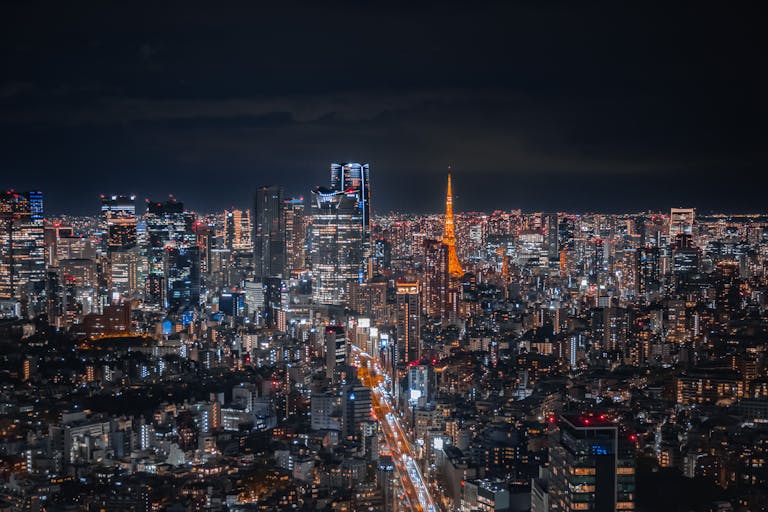 A breathtaking view of Tokyo's skyline at night featuring the illuminated Tokyo Tower.