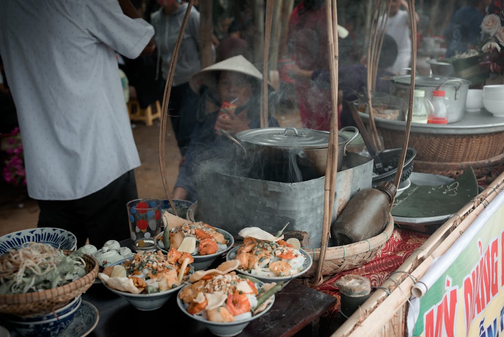 Explore the vibrant atmosphere of a traditional Vietnamese street food market with steaming dishes.